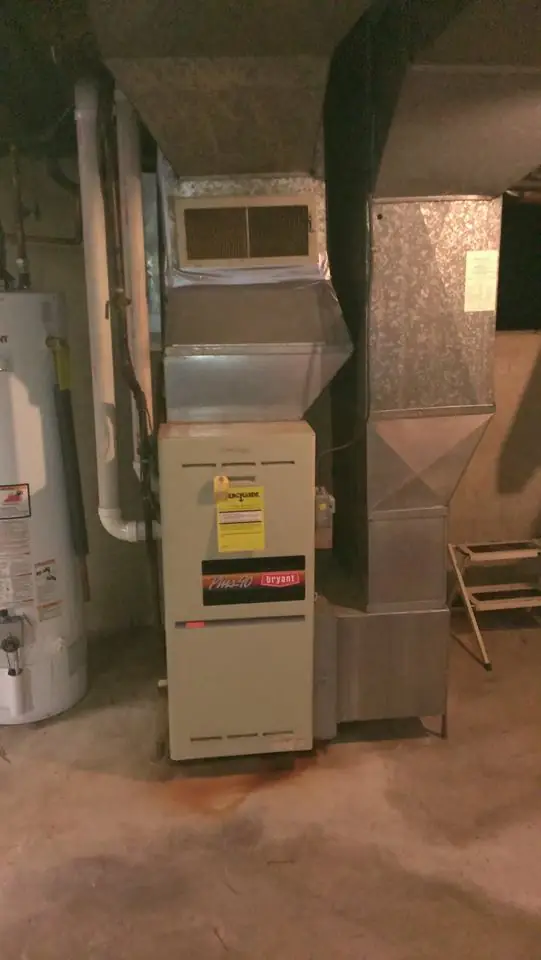A Bryant furnace and its ductwork in a DeKalb basement, closeup on the unit