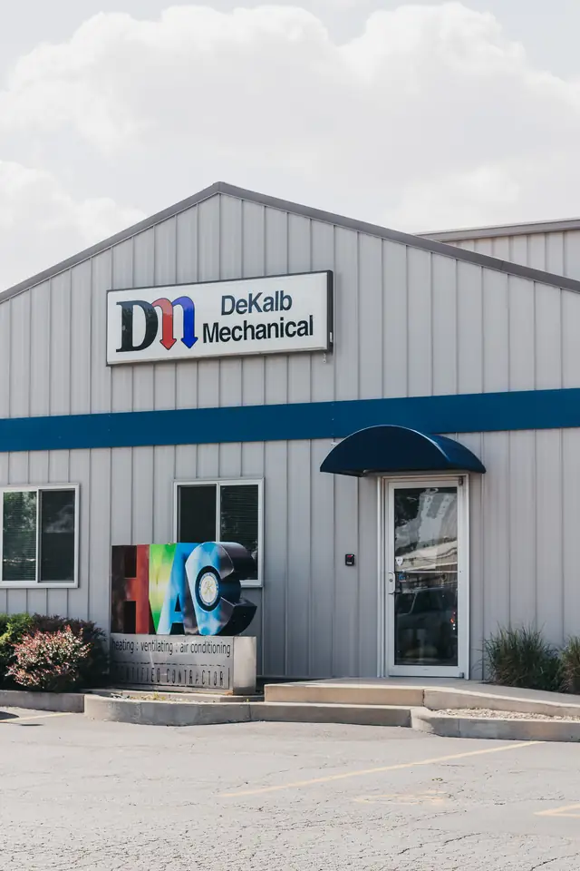 The entrance to DeKalb Mechanical on Wurlitzer Drive, with the company sign and the HVAC certified contractor monument sign outside