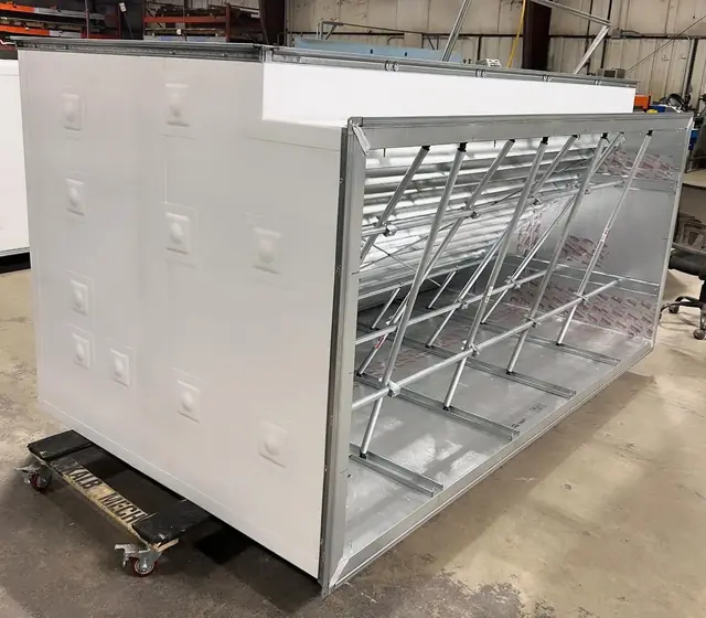 A finished custom Thermaduct unit on a cart, stencilled DEKALB MECH, ready to leave the shop