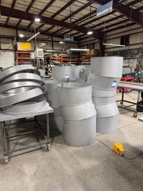 Gorelocked paint-grip round duct stock standing in DeKalb Mechanical's shop