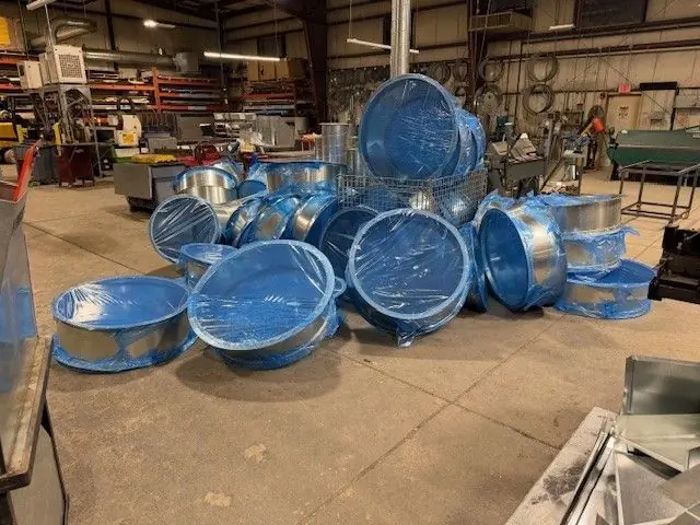 Large round duct stock, wrapped and ready to ship, in DeKalb Mechanical's shop